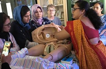 Participants in healthcare training session with mannequin
