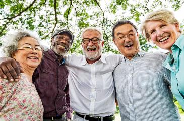 Group of older people with arms linked