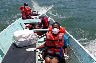 people wearing lifejackets on boat in water