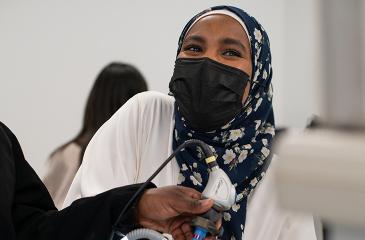 Woman with mask and headscarf in a clinic