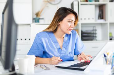 female health professional using laptop