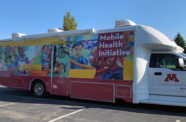 A mobile health initiative truck parked in a parking lot.