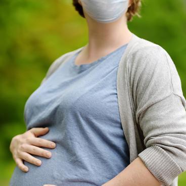pregnant person with face mask